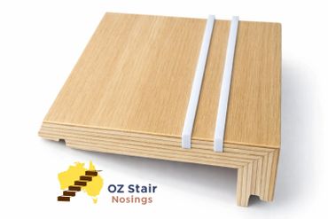 Wooden stair nosing with white anti-slip strips.