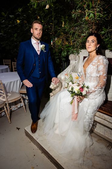 Bride and groom posing with matching blush and ivory bouquet and buttonhole at sefton pakm house