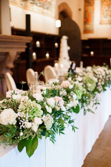 Luxurious long top table floral design made with roses, hydrangea and sweetpeas.