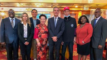 Group of grant recipients standing with Mayor Eric Garcetti inside Hop Woo.