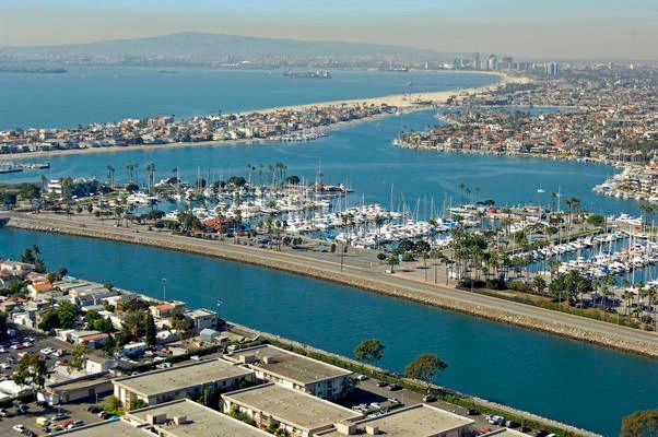 A coastal city with marinas and waterways under a clear sky.