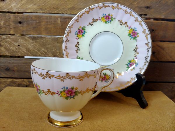 1970s Royal Grafton Tea Cup and Saucer
with pinks and yellow bands, floral garland
Tea Leaf Reading