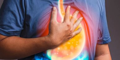Apatient experiencing GERD/Acid Reflux symptoms, indicating discomfort and potential digestive issues