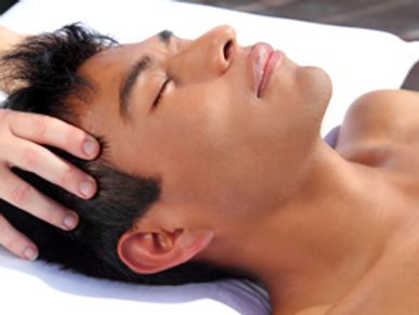 Patient receiving craniosacral therapy treatment from a therapist.