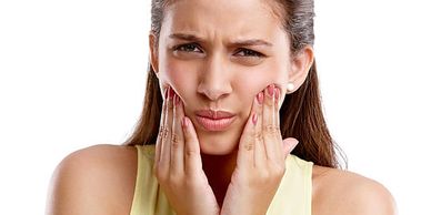 Patient experiencing TMJD jaw pain, seeking relief and treatment.