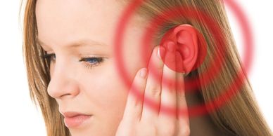 A patient experiencing ear ringing or tinnitus, a common symptom of TMJD.