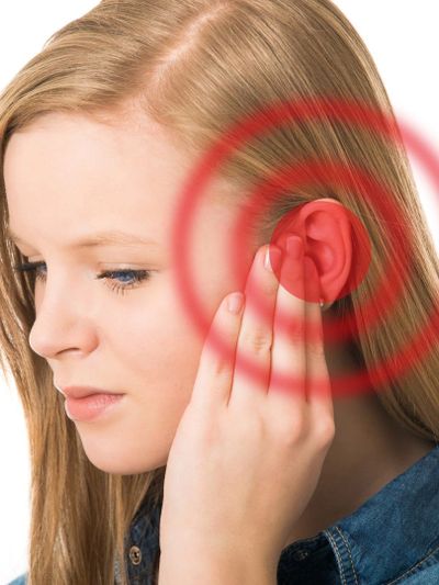 A patient experiencing ringing in the ear, a common symptom associated with TMJD