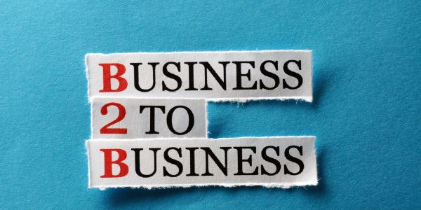 Cut-out text 'Business 2 Business' on blue background.