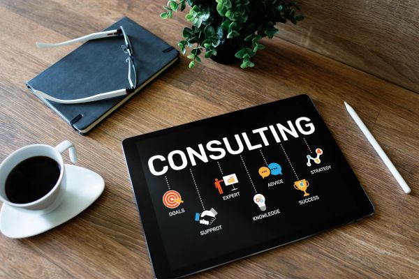 Tablet displaying consulting concepts on a wooden desk.