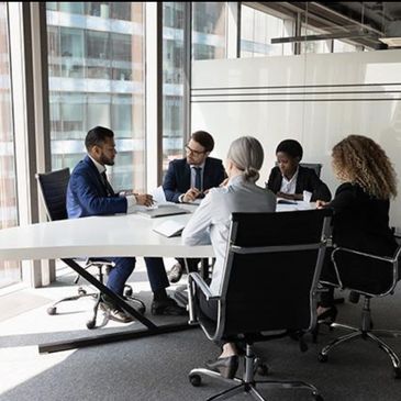 Four professionals in a business meeting.