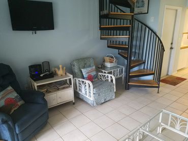 Part of Living room, circular stairway to upstairs bedroom. island vacation rentals