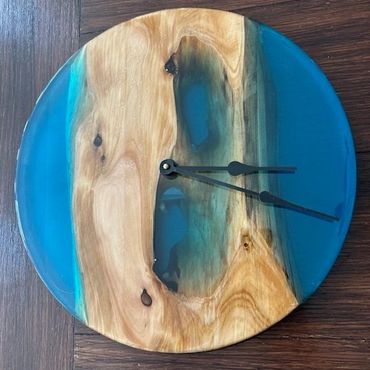 Round wooden and blue resin wall clock.