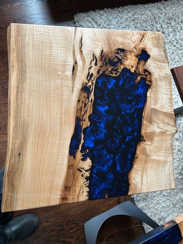 Wood table with blue resin inlay.