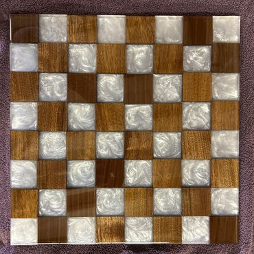 Checkerboard with alternating wooden and pearlescent white squares.