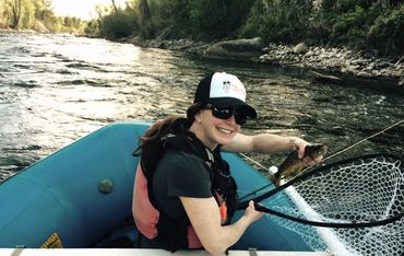 Woman in raft fishing