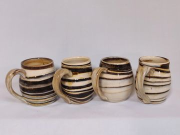 Black, brown, tan and white, in a clear glaze.
