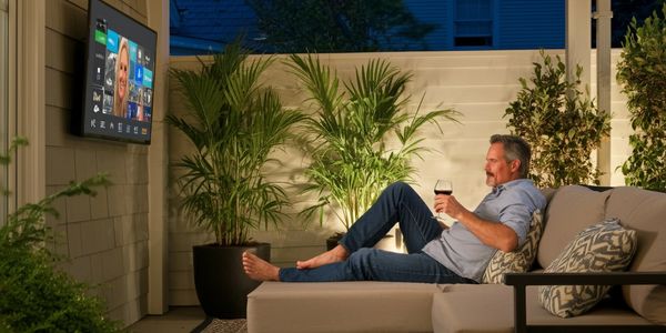 Middle age man watching outdoor entertainment.