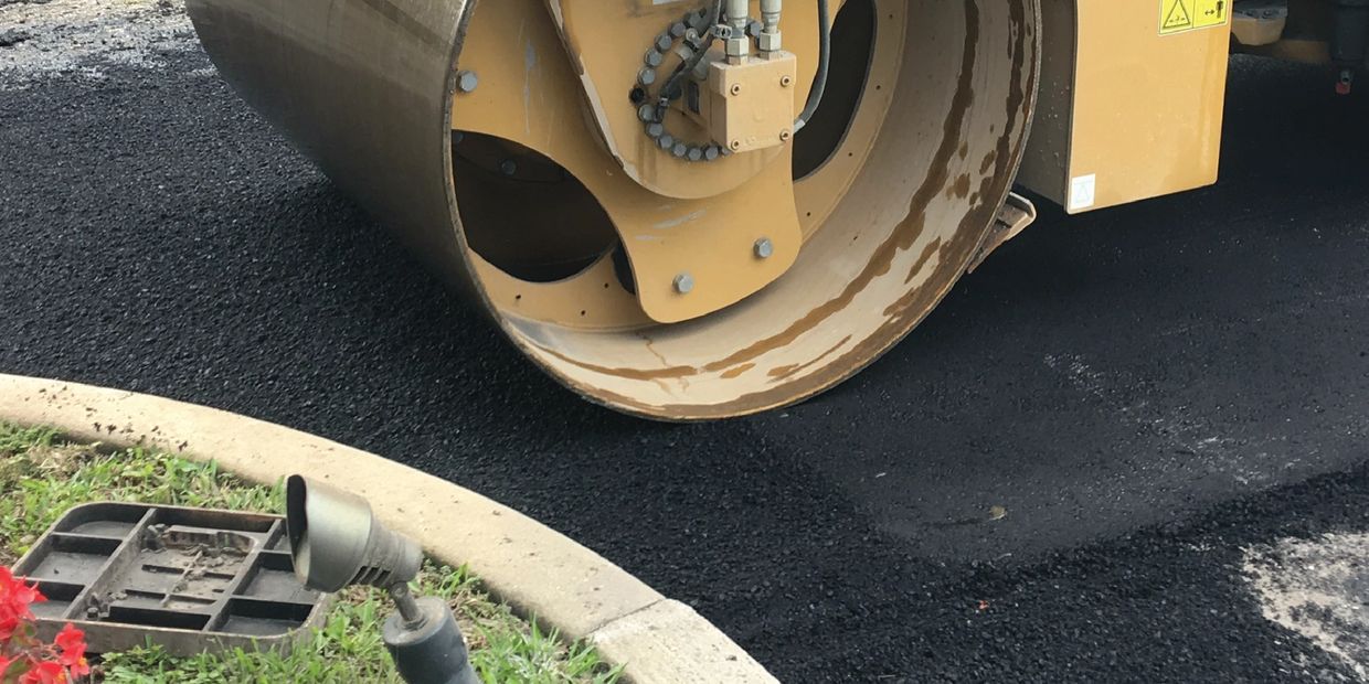 Roller compacted asphalt overlay on top of a milled roadway surface.