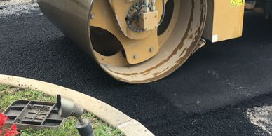 Paving Design.  Photo showing pavement being placed by a machine.