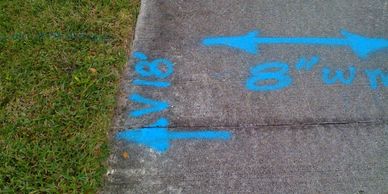 Utilities Design.  Photo showing utility marking on a concrete sidewalk.