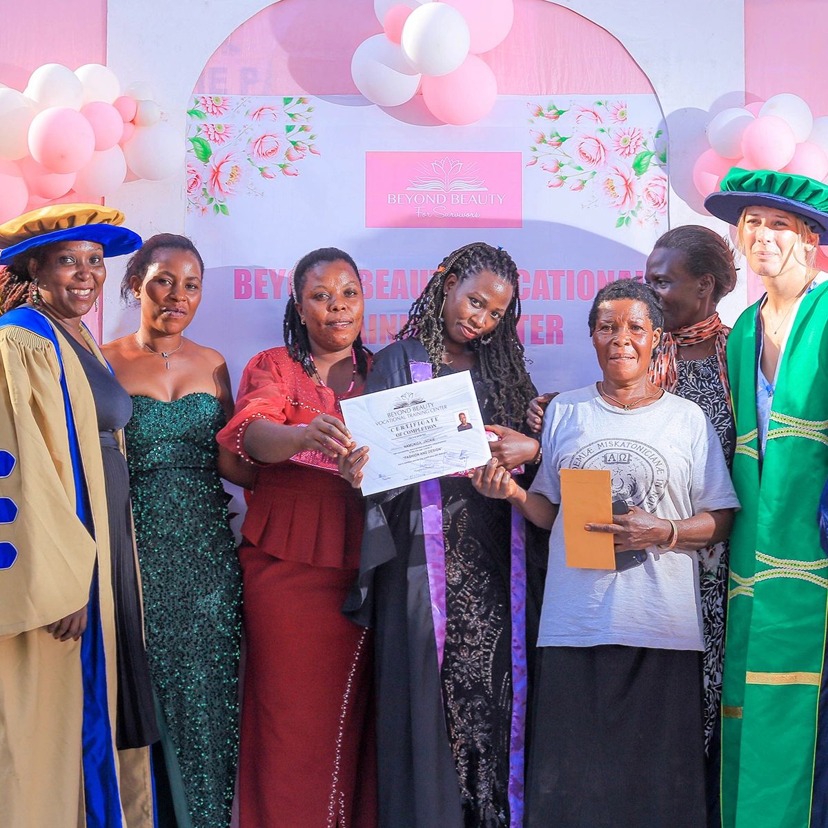 Group of women celebrating at a Beyond Beauty graduation event.