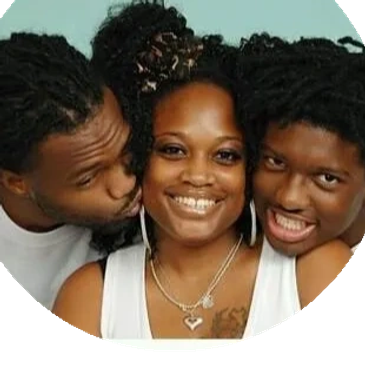A woman smiling with two men close to her.
