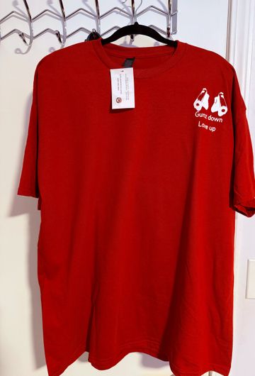 Red t-shirt with small white graphic and text on the chest.