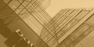 Upward view of a modern glass office building.