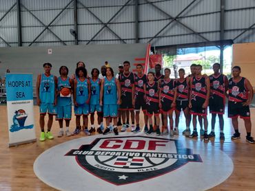 Two youth basketball teams posing on an indoor court at Club Deportivo Fantastico.