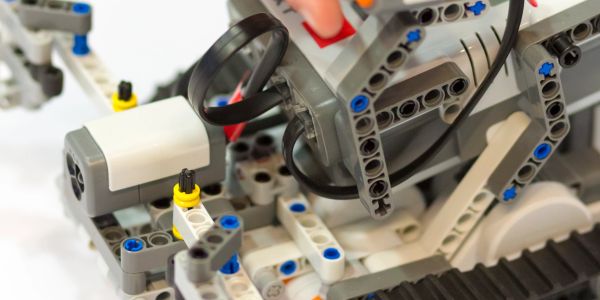 Close-up of LEGO Technic robot parts with wires.