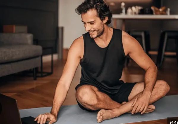 A pranayama breathing course student interacts with his laptop.