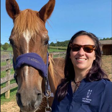 Gillian (nutrition consultant) standing to the right of Emma, a chestnut horse with a white blaze.