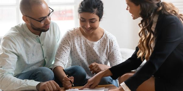 lady showing a couple were to sign a lease