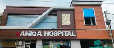 Front view of Aniqa Hospital building with clear signage.