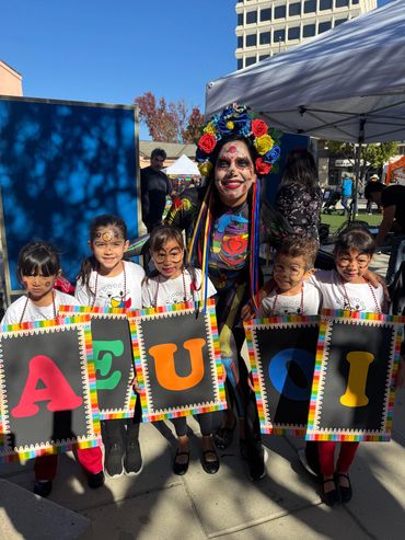 Children with colorful letter signs at Dulce Tricolor Venezuelan cultural event Bay Area