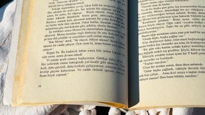 Open copy of Momo by Michael Ende resting on linen in the morning light.