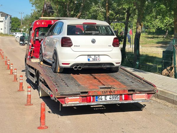 White Volkswagen Polo on a tow truck.