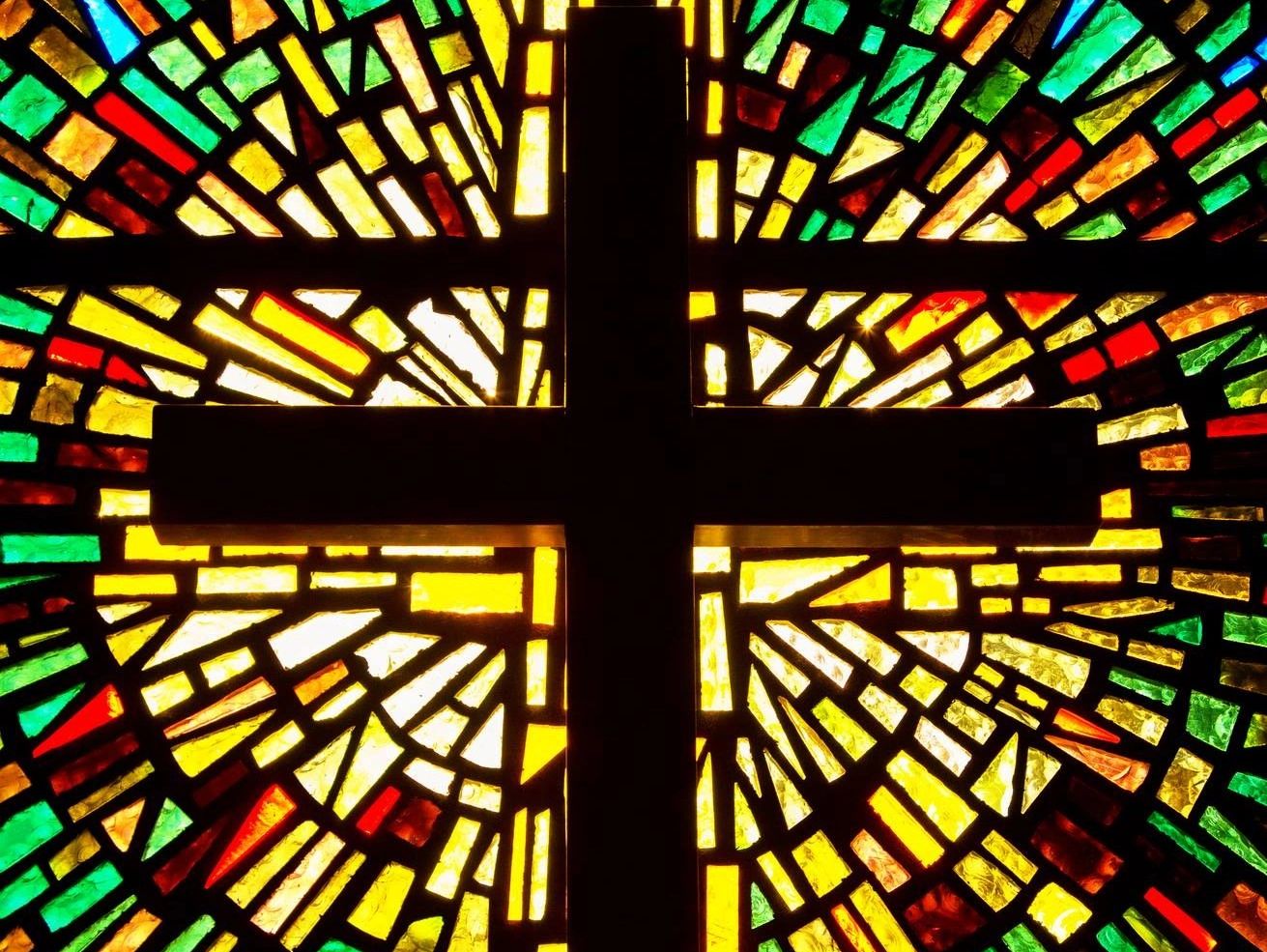 Stain glass of a Christian cross.