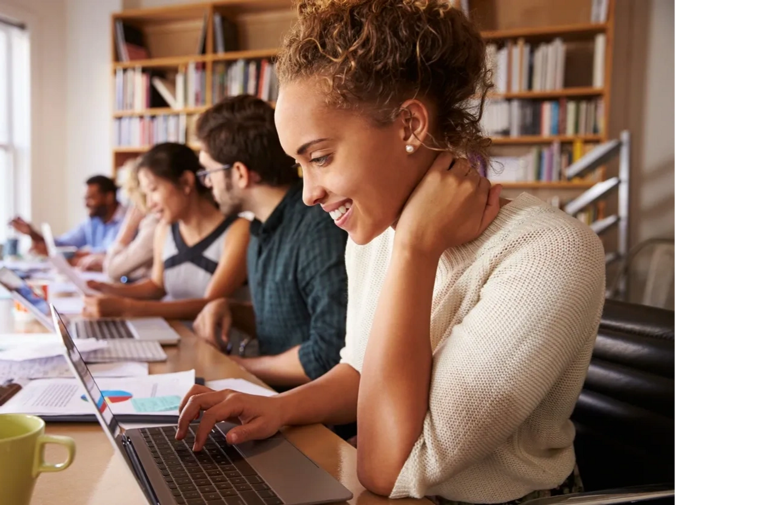 A row of high school students working online enjoying the educational experience