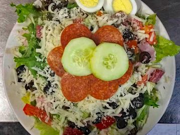 Salad with pepperoni and cucumber slices.