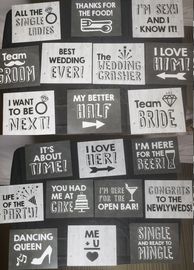 Hand held signs, lots of fun wedding phrases, white, black gray lettering, some bubble lettering.