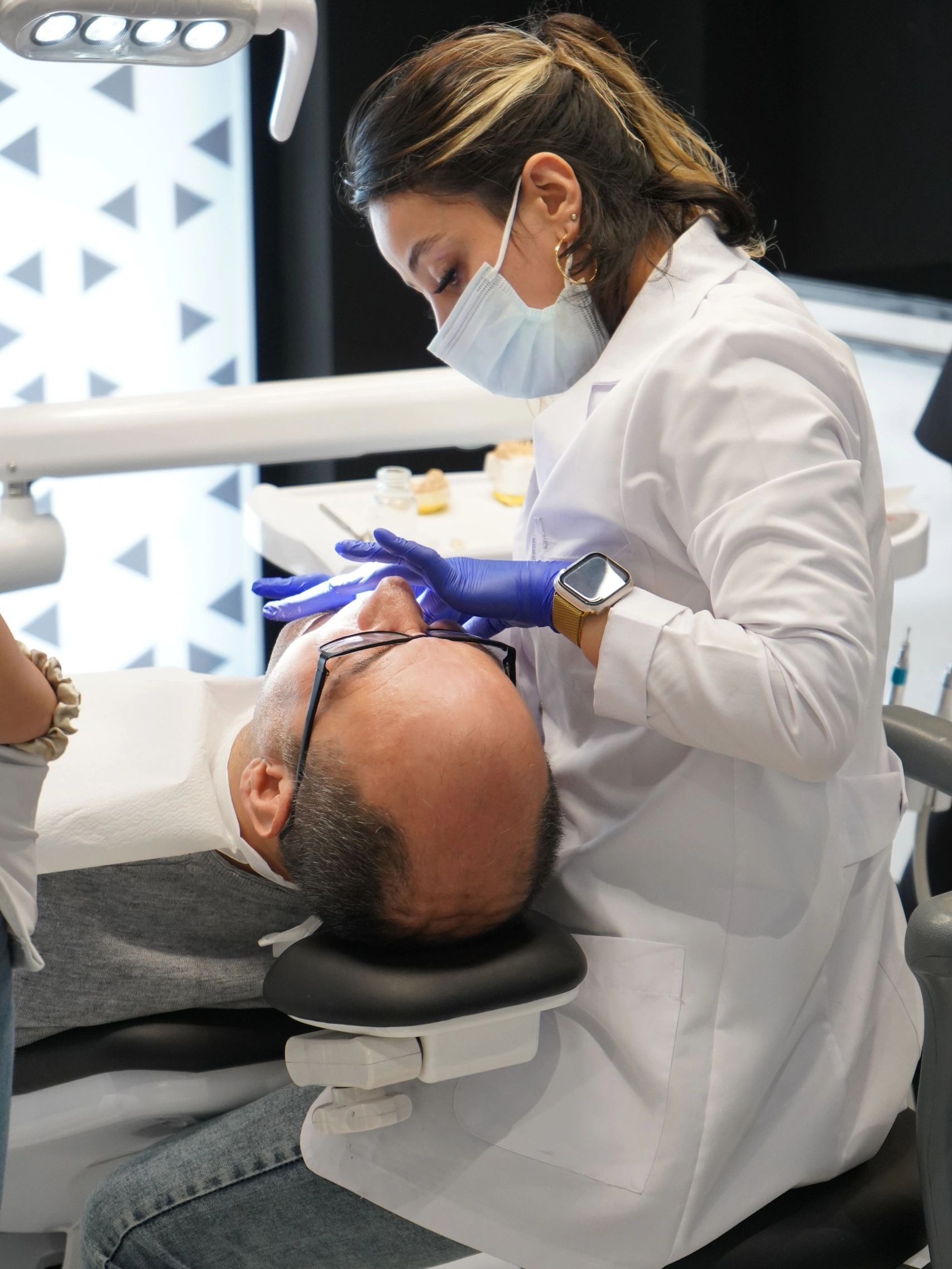 Dentist examining a patient's mouth.