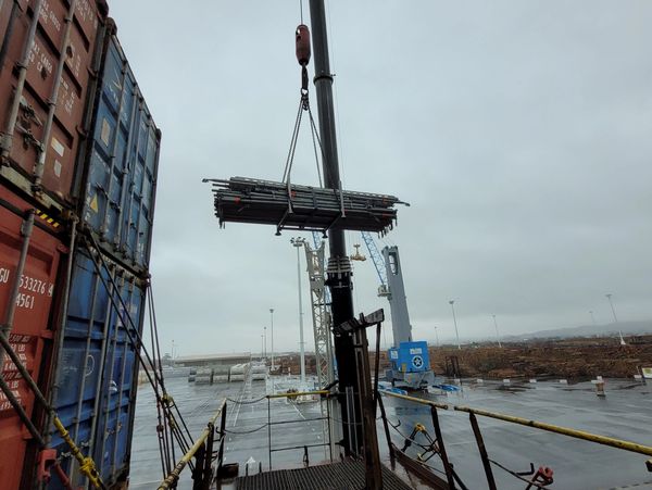 Lifting scaffolding equipment in by crane at Northport in Ruakaka