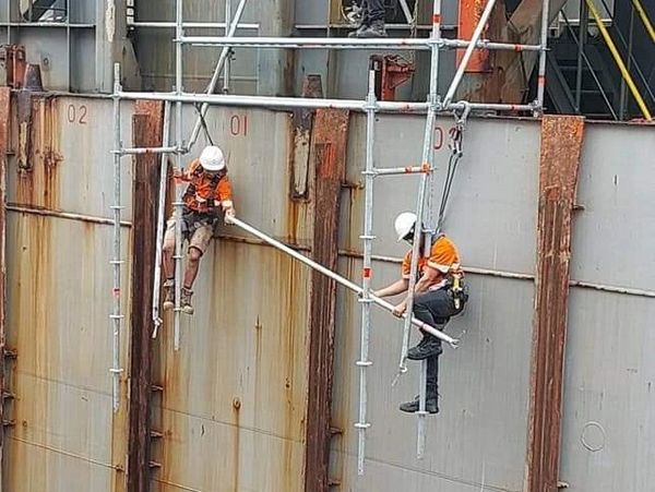 Erecting hanging scaffolding on a container ship at Northport, Ruakaka.