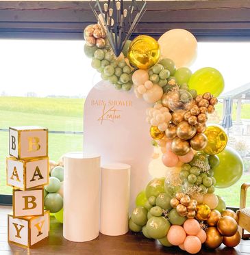 Elegant baby shower setup with balloons and blocks.