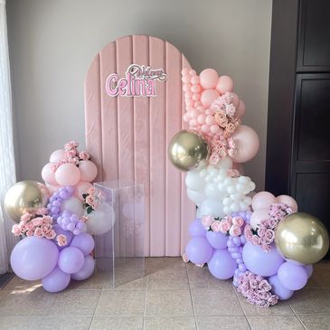 Elegant balloon and flower backdrop welcoming Celina in pastel colors.
