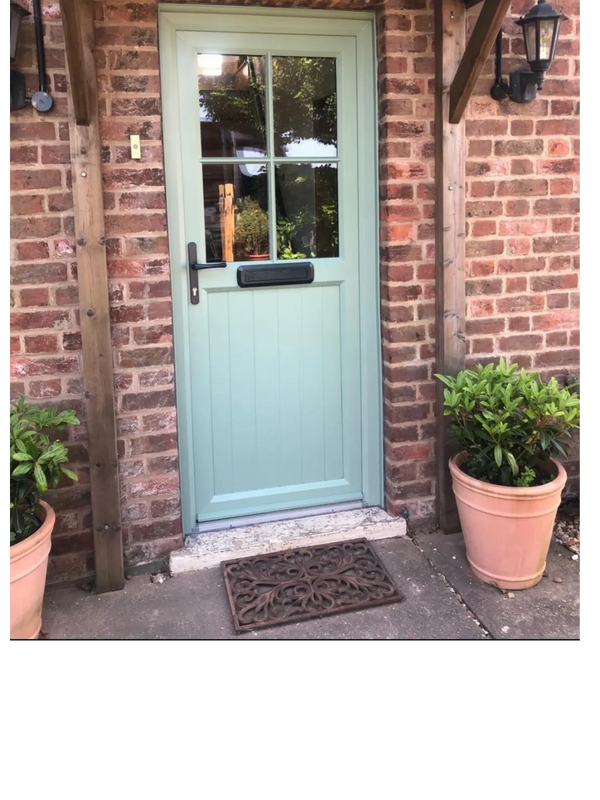 Chartwell green upvc door with astragal bar finish on glazing and heritage black handle and letterbox