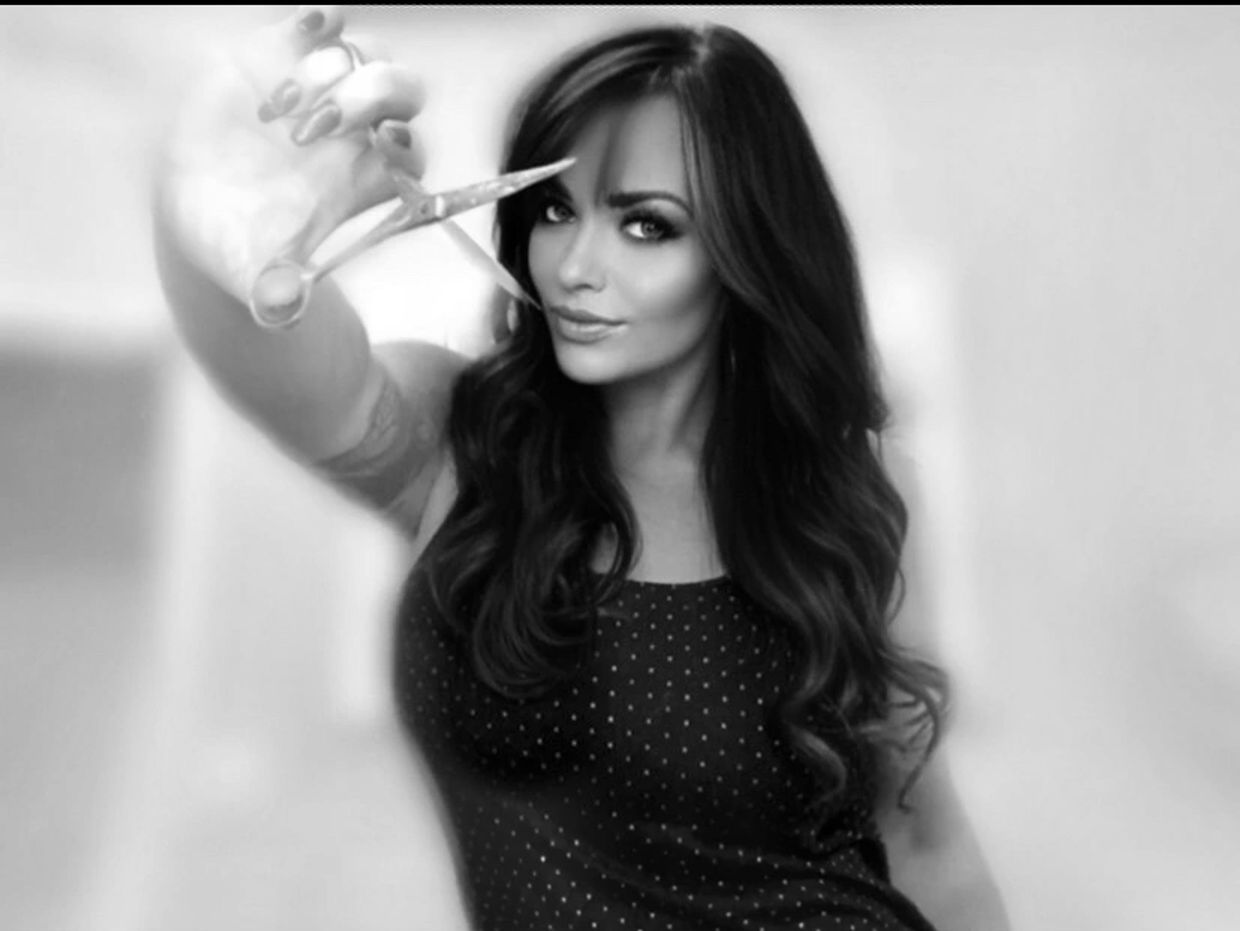 Brunette hairstylist with scissors