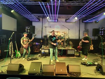 A band performing in JCI Live Room with light show