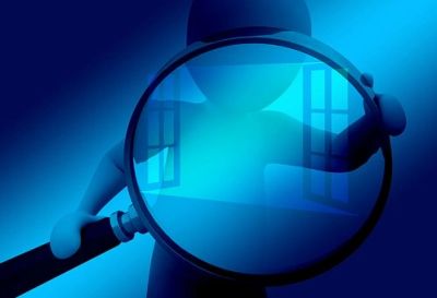 Blue figure examining through a magnifying glass with window reflections.